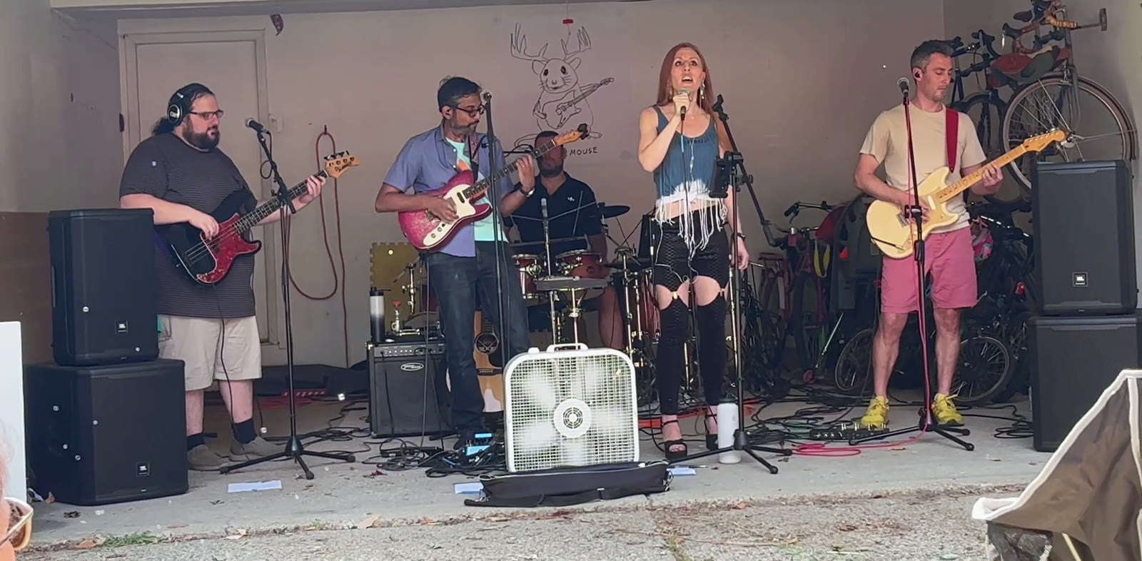 deermouse playing live at a show: bass, guitar, lead vocals, guitar, with drums behind